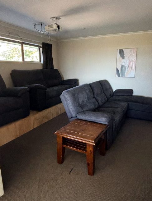 Cinema lounge with projector screen and sofas