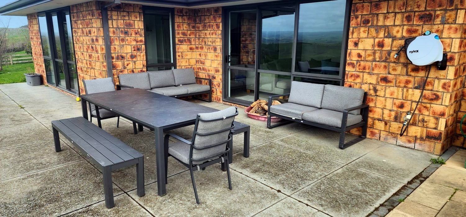 Outdoor dining and lounge on the patio with rural views