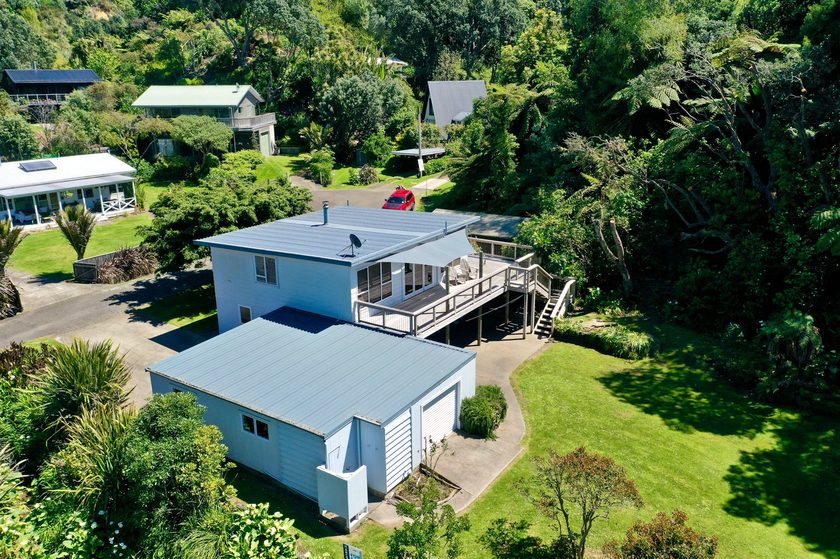 The two-storey home from above, set in native greenery